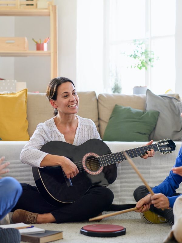 group-of-homeschooling-children-with-teacher-having-music-lesson-indoors-coronavirus-concept-1-1.jpg